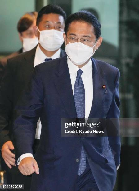 Japanese Prime Minister Fumio Kishida arrives at his office in Tokyo on Aug. 9 wearing a face mask for protection against COVID-19.