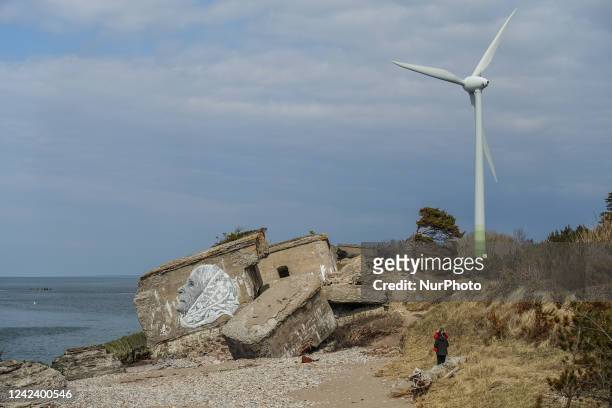 Wind turbine converting the kinetic energy of wind into electrical energy over the Artillery battery No.1 ruins are seen in Liepaja, Latvia , on 1...