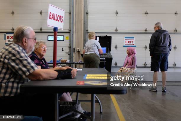 Poll workers and voters participate during Wisconsins state primary day on August 9, 2022 at the Village Hall of Waukesha in Waukesha, WI. The race...