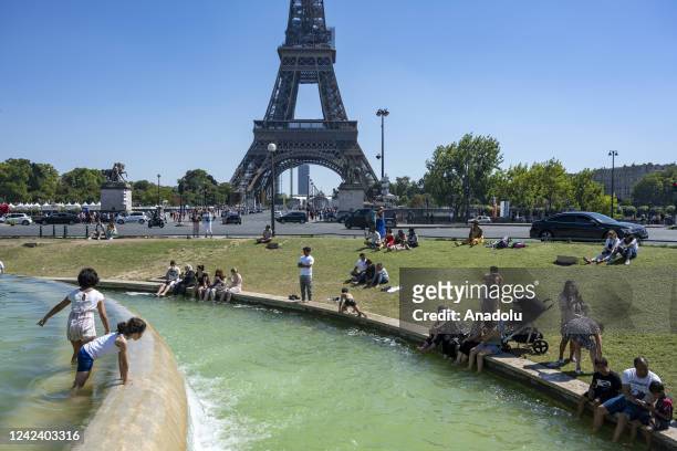 People cool off near the Fontaine of the Trocadero garden in Paris, France on August 9, 2022.