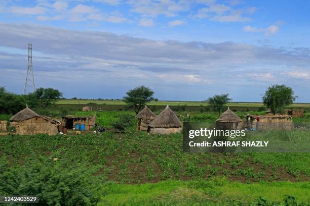 General view shows huts along the highway that connects Sudan's southern Blue Nile state to the capital Khartoum, on August 9, 2022.
