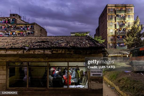 Electoral Commission Officials count votes inside a polling station after the official closing of the polls during Kenya's general election at...