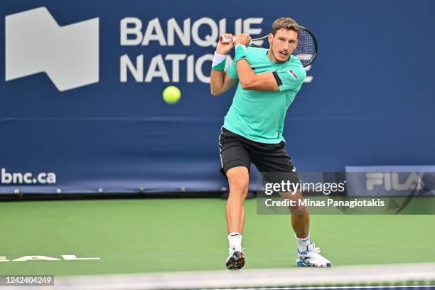 Pablo Carreno Busta of Spain hits a return against Matteo Berrettini of Italy during Day 4 of the National Bank Open at Stade IGA on August 9, 2022...