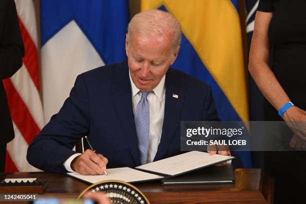 President Joe Biden signs the Instruments of Ratification for the Accession Protocols to the North Atlantic Treaty for the Republic of Finland and...