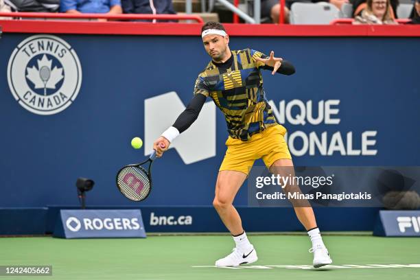 Grigor Dimitrov of Bulgaria hits a return against Alexis Galarneau of Canada during Day 4 of the National Bank Open at Stade IGA on August 9, 2022 in...