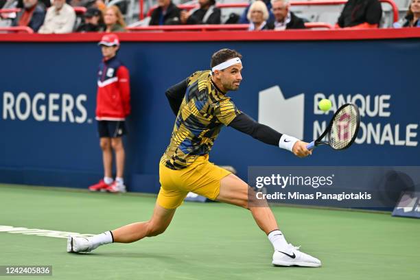 Grigor Dimitrov of Bulgaria hits a return against Alexis Galarneau of Canada during Day 4 of the National Bank Open at Stade IGA on August 9, 2022 in...