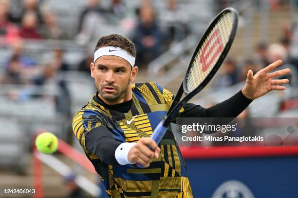 Grigor Dimitrov of Bulgaria hits a return against Alexis Galarneau of Canada during Day 4 of the National Bank Open at Stade IGA on August 9, 2022 in...