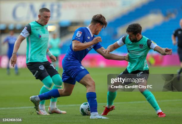 Ollie Tanner of Cardiff City FC, Ronan Curtis and Joe Rafferty of Portsmouth during the Carabao Cup First Round match between Cardiff City and...