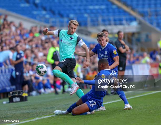 Oliver Denham and Vontae Daley-Campbell of Cardiff City FC and Joe Pigott of Portsmouth during the Carabao Cup First Round match between Cardiff City...
