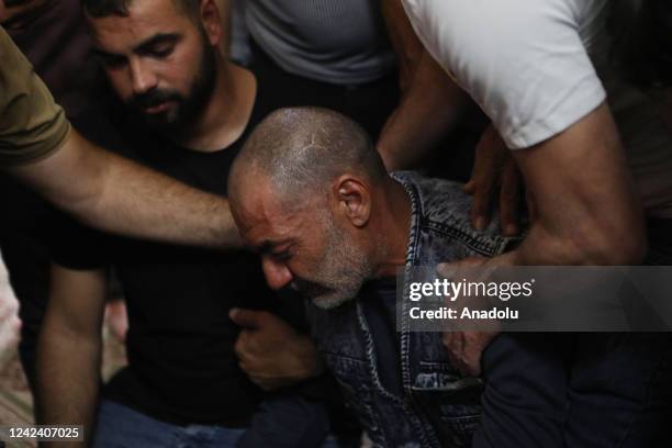 Relatives mourn as Palestinians gather to attend the funeral ceremony held for Palestinian Moamen Yassin Jaber shot in chest by Israeli forces and...