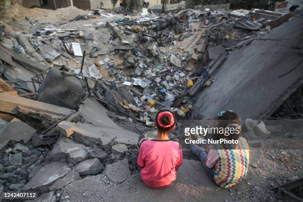 Palestinian children inspect their damaged building in Gaza city on August 9, 2022 after a ceasefire between Israel and Palestinian militants came...