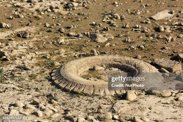 A car tire lies on the dry bank of Rhine river in Bad Honnef, germany on August 9, 2022 Euroe is being hit by climate crsisi.