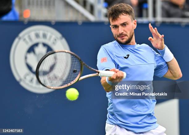 Pedro Martinez of Spain hits a return against Gael Monfils of France during Day 4 of the National Bank Open at Stade IGA on August 9, 2022 in...