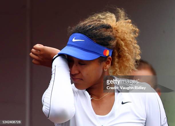 Naomi Osaka of Japan wipes a tear after she retired early from her match against Kaia Kanepi of Estonia during the National Bank Open, part of the...