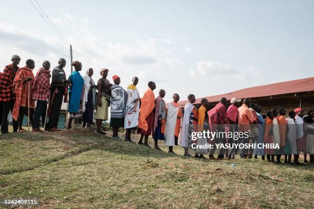 People queue to vote for Kenya's general election at the Masurura primary school polling station in Masurura on August 9, 2022.