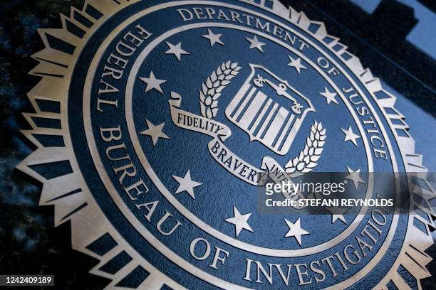 Seal reading "Department of Justice Federal Bureau of Investigation" is displayed on the J. Edgar Hoover FBI building in Washington, DC, o August 9,...