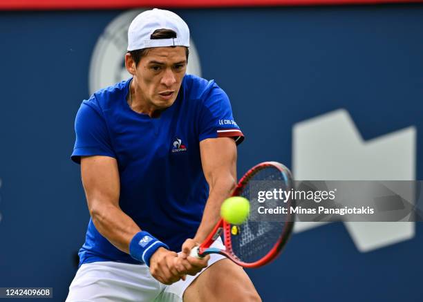 Sebastian Baez of Argentina hits a backhanded return against Nick Kyrgios of Australia during Day 4 of the National Bank Open at Stade IGA on August...