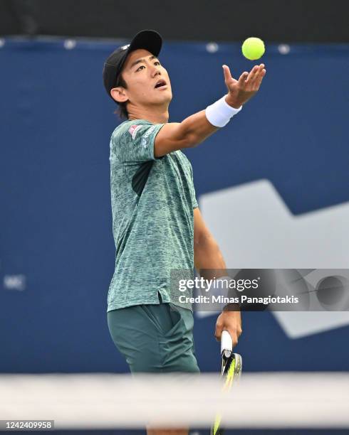 Yoshihito Nishioka of Japan serves against Benoit Paire of France during Day 4 of the National Bank Open at Stade IGA on August 9, 2022 in Montreal,...