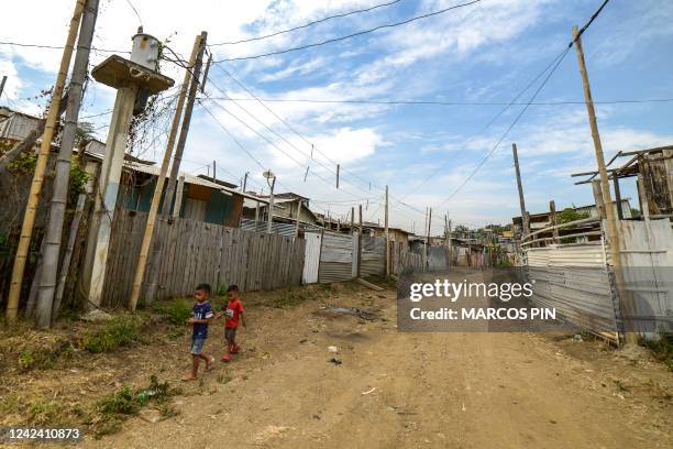 Children walk in the Cañaveral neighbourhood of the Ciudad de Dios cooperative in the Monte Sinai sector of Guayaquil, Ecuador, on July 26, 2022....