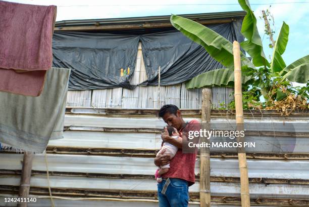 José Mojica carries his daughter Joselyn Mojica, in his house located in the Cañaveral neighbourhood of the Ciudad de Dios cooperative, in the Monte...