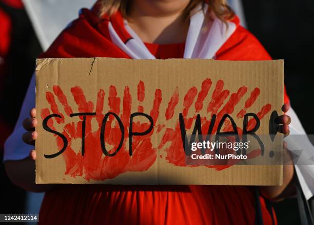 Protester holding a placard with words 'Stop War!. Members of the local Belarusian and Ukrainian diaspora supported by local Cracovians during the...
