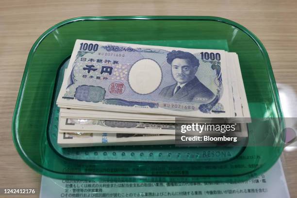 Japanese yen banknotes on a tray arranged at a branch of Resona Bank Ltd. In Tokyo, Japan, on Tuesday, Aug. 9, 2022. Dollar-yen, which soared 38%...