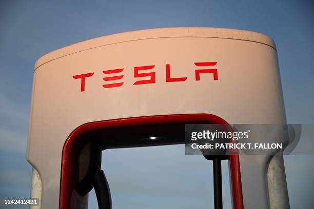 The Tesla, Inc. Electric vehicle logo is displayed on a charging bay at at supercharger location in Hawthorne, California, on August 9, 2022. Elon...