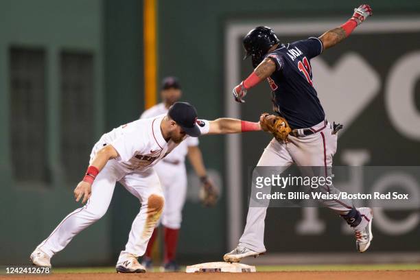 Christian Arroyo of the Boston Red Sox tags out Orlando Arcia of the Atlanta Braves during the tenth inning of a game on August 9, 2022 at Fenway...