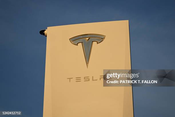 The Tesla, Inc. Logo is displayed on a sign outside the Tesla Design Center in Hawthorne, California, on August 9, 2022. Elon Musk has sold nearly $7...