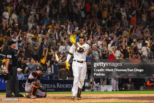 Manny Machado of the San Diego Padres tosses his bat after hitting a walk-off home run in the ninth inning against the San Francisco Giants at PETCO...