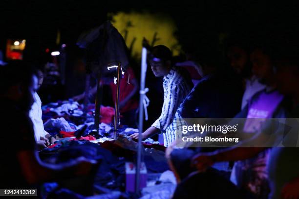 Street vendor uses USB-powered LED lights to sell his products during a load-shedding power outage period in Dhaka, Bangladesh, on Tuesday, Aug. 9,...