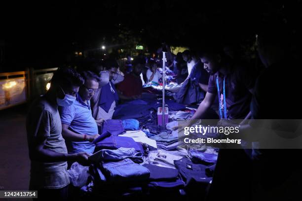 Street vendor uses USB-powered LED lights to sell his products during a load-shedding power outage period in Dhaka, Bangladesh, on Tuesday, Aug. 9,...