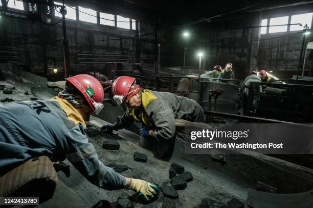 Workers in the coal sorting area in a coal mine in the eastern Donbas region in Ukraine, 26th of July 2022.