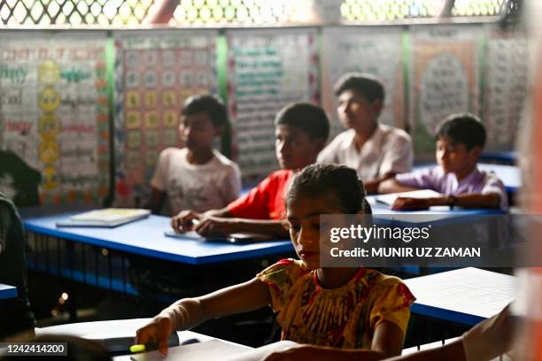 Rohingya refugee children attend a class at a school in Kutupalong refugee camp in Ukhia on August 10, 2022.