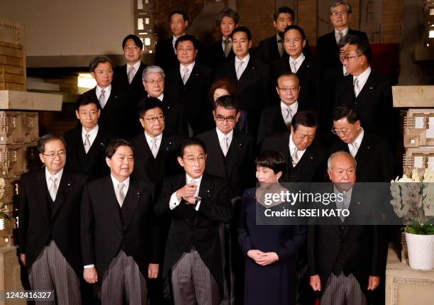 Japan's Prime Minister Fumio Kishida and his cabinet ministers attend a photo session at the prime minister's official residence in Tokyo on August...
