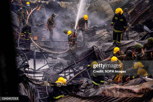 Firefighters along with the help of the Army and Police personnel douse a fire that broke out in a shoe factory caused by a short circuit at Balaju.