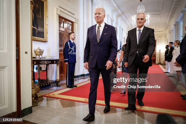 President Joe Biden and Secretary of Veterans Affairs Denis McDonough walk through the Cross Hall to the East Room for a signing ceremony for The...