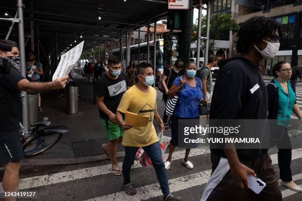 Group of migrants leaves Port Authority Bus Terminal after their bus arrived from Texas on August 10, 2022 in New York. - Texas has sent thousands of...