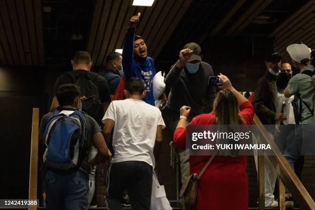 Group of migrants reacts after arriving at Port Authority Bus Terminal from Texas on August 10, 2022 in New York. - Texas has sent thousands of...