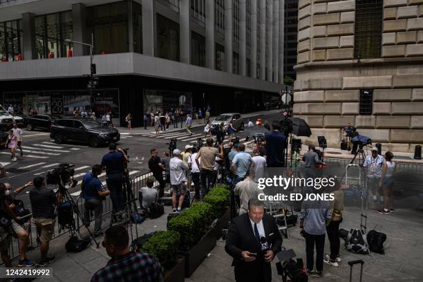 General view shows members of the media and spectators waiting outside the New York Attorney General's office, where former US President Donald Trump...