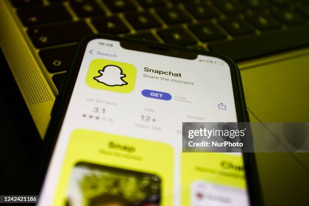 Snapchat on the App Store displayed on a phone screen and a laptop keyboard are seen in this illustration photo taken in Krakow, Poland on August 10,...