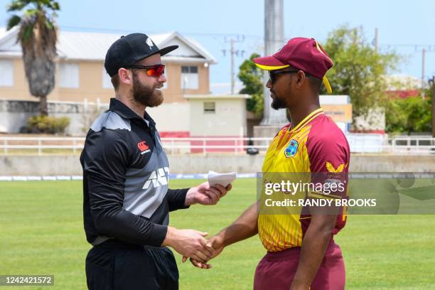 Kane Williamson , of New Zealand, and Nicholas Pooran , of West Indies, shake hands before the coin toss during the first T20i match between West...