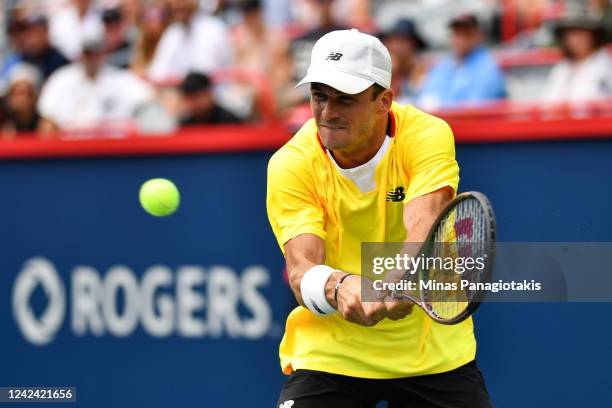 Tommy Paul of the United States hits return against Carlos Alcaraz of Spain during Day 5 of the National Bank Open at Stade IGA on August 10, 2022 in...