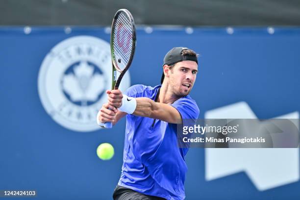 Karen Khachanov hits a return against Marin Cilic of Croatia during Day 5 of the National Bank Open at Stade IGA on August 10, 2022 in Montreal,...