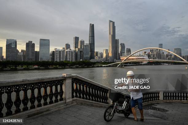 This photo taken on July 15 shows a man walking at central business district in Guangzhou, in China's southern Guangdong province.