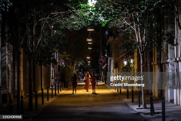 Retail stores, with their main lighting switched off following new rules requiring businesses to turn off their lights at night, along the Passeig de...