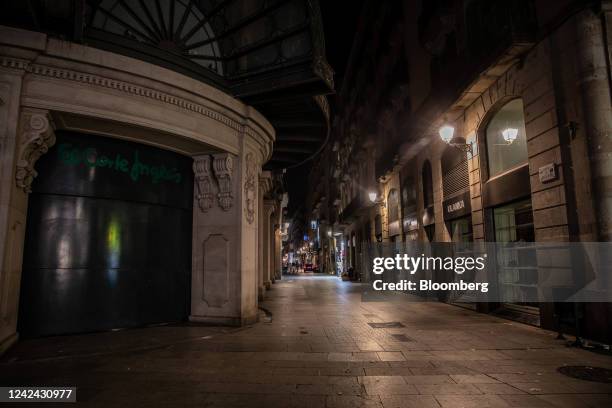 Retail stores on the Portal del Angel, with the main lighting switched off following new rules requiring businesses to turn off their lights at...