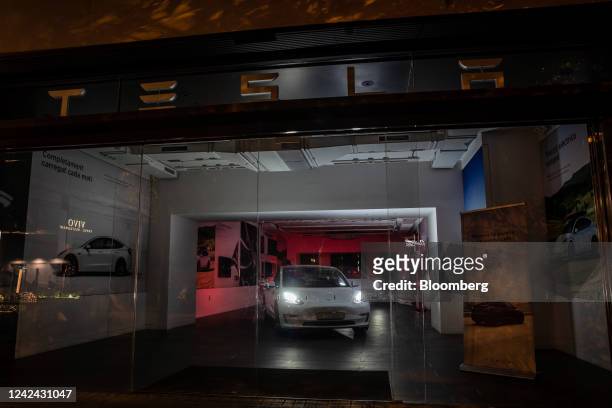 Tesla Inc. Showroom, with the main lighting switched off following new rules requiring businesses to turn off their lights at night, in Barcelona,...