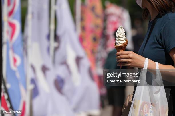 Woman holds an ice cream cone at the Dangozaka service area on the Chuo Expressway in Uenohara, Yamanashi Prefecture, Japan, on Thursday, Aug. 11,...