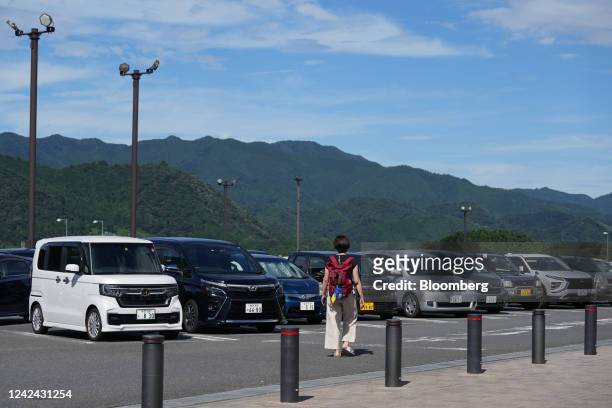 Woman towards a car in the Dangozaka service area on the Chuo Expressway in Uenohara, Yamanashi Prefecture, Japan, on Thursday, Aug. 11, 2022. The...